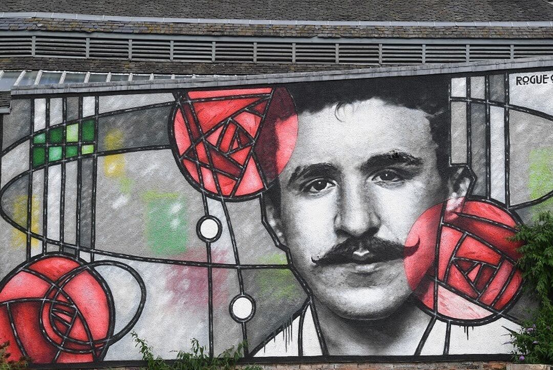 A mural of Charles Rennie Mackintosh in the distinctive art deco and rose motif style.